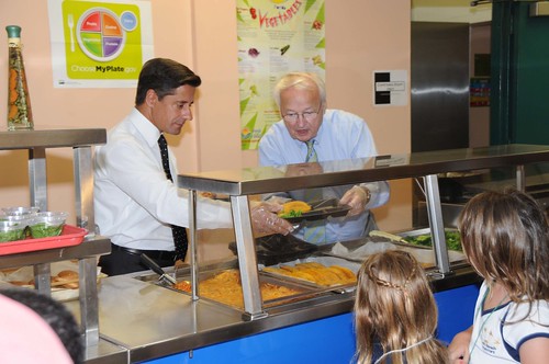 US Kevin Concannon and Miami-Dade County School Superintendent Alberto Carvalho serve lunch to students from North Beach Elementary School, Miami, FL, on August 23, 2012. (USDA photo by Debbie Smoot).