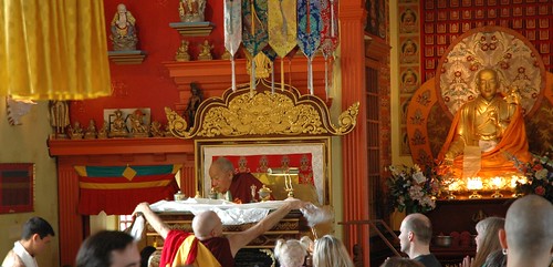 Venerable Lekshe gives His Holiness Dagchen Sakya a white ritual katag placing it across his desk, statue of Sakya Kunga Nyingpo to the right, throne, shrine room, Sakya Monastery of Tibetan Buddhism, Seattle, Washington, USA by Wonderlane