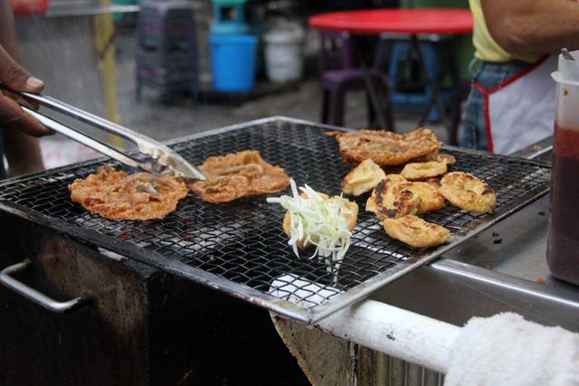 Roasting the rojak ingredients over charcoal