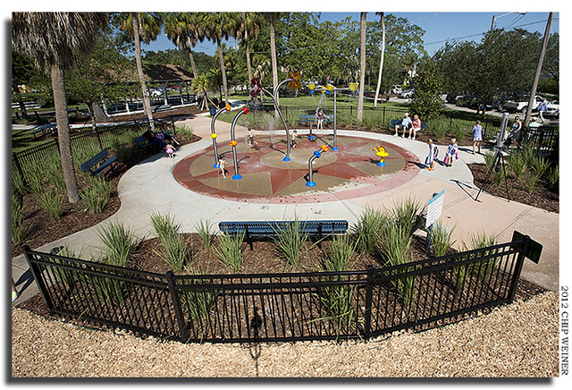 Children play in the new splash pad at the tot lot of Ballast Point Park