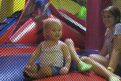 Lucy & me in the bounce house. The extra pair of legs there belong to Catie.