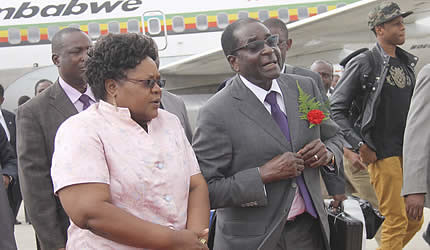 Republic of Zimbabwe Robert Mugabe with Vice President Joice Mujuru at the airport during the president's return from holiday. The photo was taken on January 10, 2013. by Pan-African News Wire File Photos