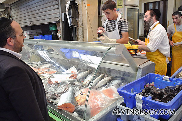 An ultra-orthodox man buying fish