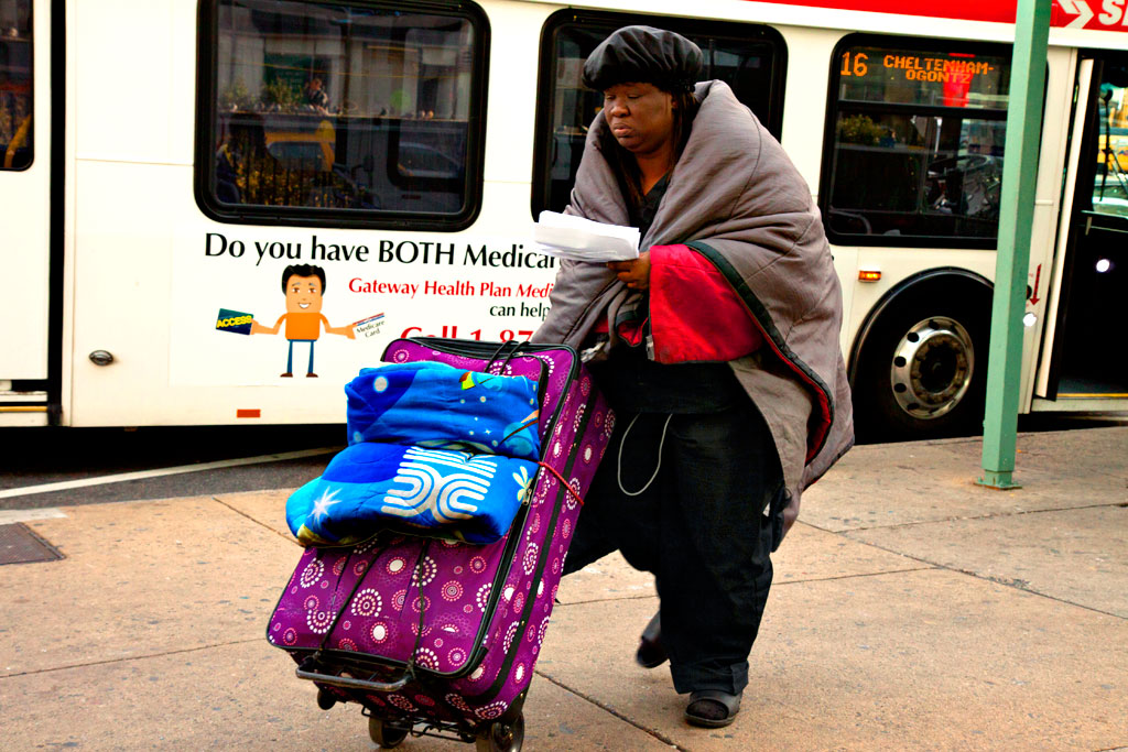 Homeless-woman-pushing-large-suitcase-on-11-16-12--Center-City