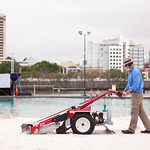 Vacuuming the sand.