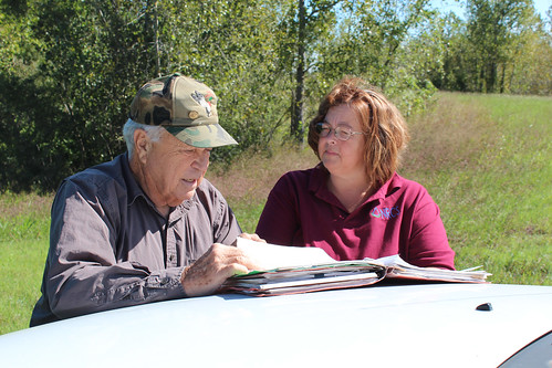 Ron Farris, landowner, and NRCS employee Danette Cross look over his conservation plan.