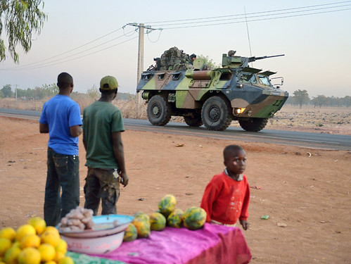 Malian people look at a French armoured vehicle as French soldiers leave Bamako and start their deployment to the north of Mali as part of the operations on January 15, 2013 . by Pan-African News Wire File Photos