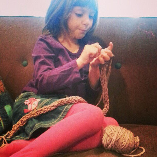 Ada, finger knitting a scarf for her teacher.