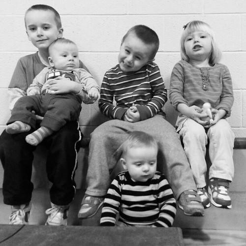 CouSins at the 10 am toilet bowl b Bball game .  Cute kids watching their uncle.
