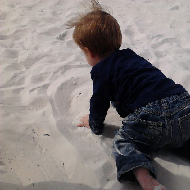 Playing in the sand ... which he keeps calling snow.