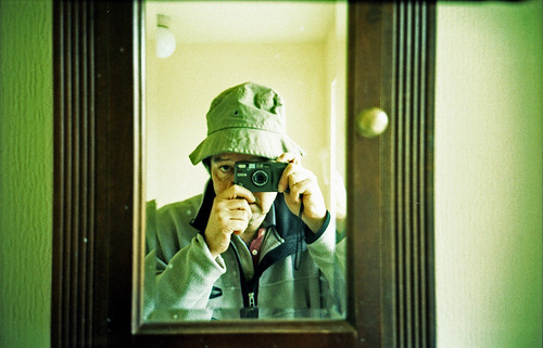 reflected self-portrait with Ricoh R1 camera and canvas hat by pho-Tony