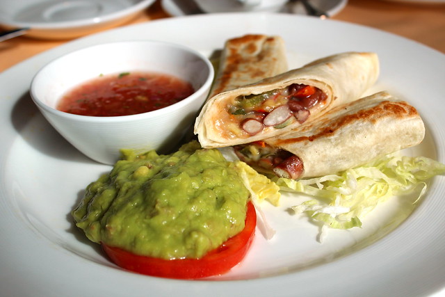 Vegetarian Burrito with char-broiled vegetables and red kidney beans, guacamole, Mexican salsa
