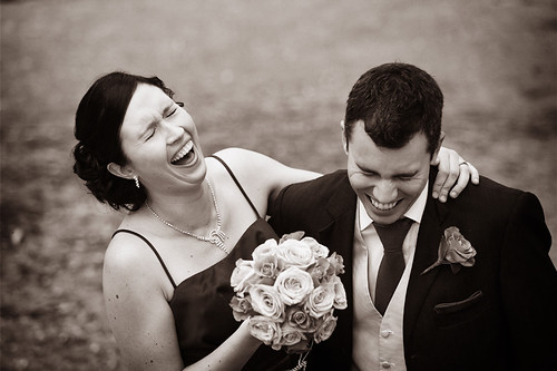 Laughing bride and groom.