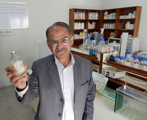 Dr. Muhammad Afzal of the UN Food and Agriculture Organization (FAO) holds a bottle of Foot and Mouth Disease (FMD) vaccine to show it becomes cloudy when it warms and is no longer usable.  USDA helps keep FMD vaccinations cold and viable through its Program for the Progressive Control of Foot and Mouth Disease (FMD) in Pakistan.