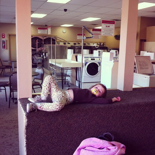 Lounging at the laundromat in my leopard pants and sequined shoes.