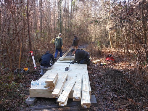 Volunteers work on 32 feet of a boardwalk through a forest area in southwest Atlanta as part of the Martin Luther King Jr. Day of Service. (US Forest Service photo)