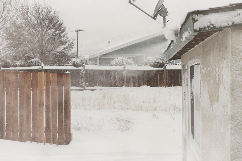 backyard-driveway-snow-fence-blowing-off-roof