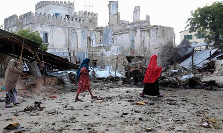 Somalian women walk past the site of a deadly blast in Mogadishu on April 14, 2013. The attacks were carried out at the Supreme Court by armed combatants. by Pan-African News Wire File Photos