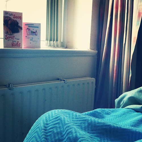 Resting in bed. Two get well cards to admire on the windowsill.