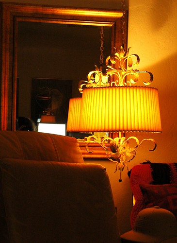 Light of 1960's Italian lamp, interior of my house, gold mirror, computer screen, sofa, leather chair custon, pith helmet - explorer's hat, pillow, San Mateo, California, USA by Wonderlane