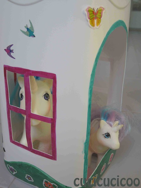 my little pony peeking out of plastic bottle house