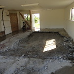 Concrete garage slab demolition and removal in progress.