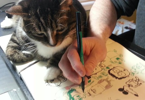 Hank sprawls out on my Moleskine sketchbook while I'm doodling