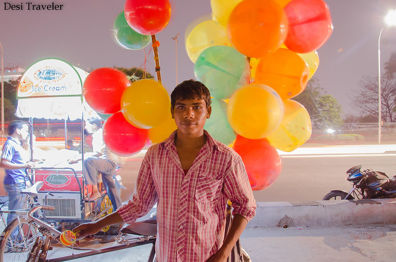 balloon seller with ice cream seller in evening  picture taken in low light photography