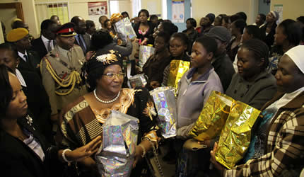 Malawi President Joyce Banda at the Kuwadzana Clinic in the Republic of Zimbabwe. She handed out gifts to the people. Banda is in Zimbabwe for the International Trade Fair in Bulawayo. by Pan-African News Wire File Photos