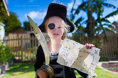 Child playing pirates with treasure map and sword