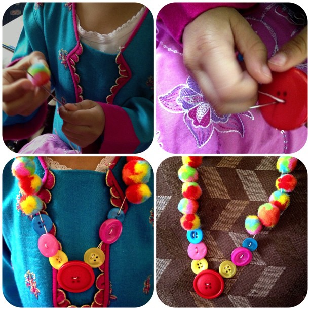 We made a Pom Pom and button necklace, my niece really enjoyed it and it was so easy for her to do #pompom #niece #buttons #rainbow #craft #child