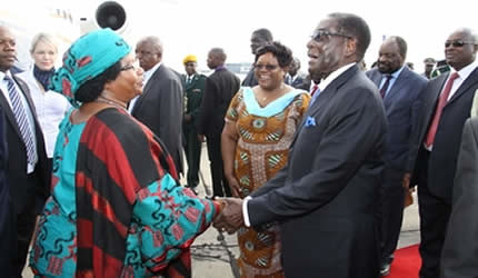 President Mugabe welcomes Malawian president Joyce Banda while Vice President Joice Mujuru looks on at the Harare International Airport April 23, 2013. The Malawian leader flew in for a State visit during which she will open the International Trade Fair. by Pan-African News Wire File Photos