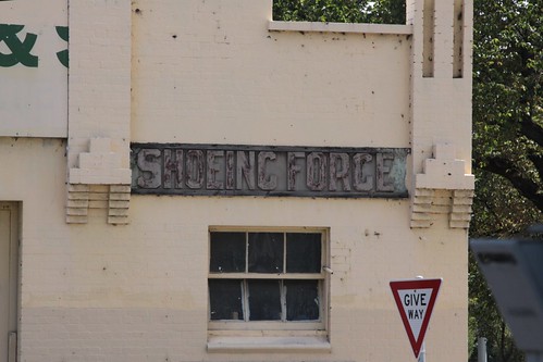 'Wheelwright' and 'Shoeing Forge' signs on the facade