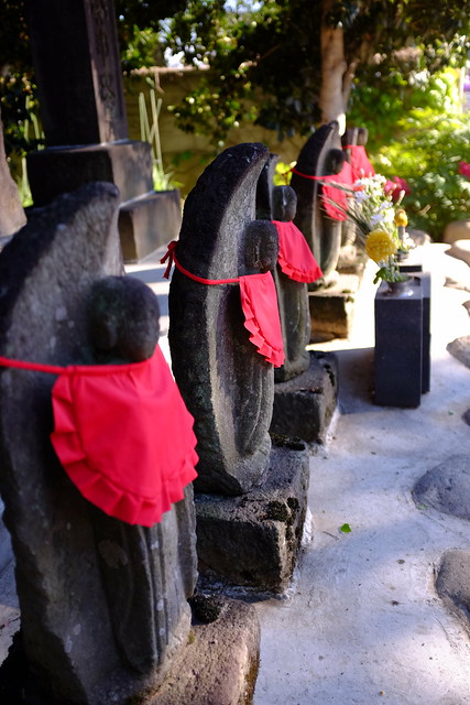 guardian deity with red apron
