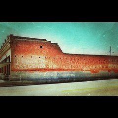 A loooonnng ghost sign covers the side of this old building in Frankston, Texas