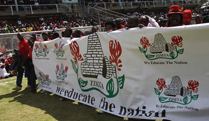 Banner from the Zimbabwe Teachers' Association on May Day 2013. The labor organization called for the lifting of economic sanctions against the Southern African State. by Pan-African News Wire File Photos