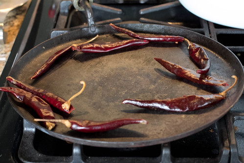 Roasting red chiles on the comal