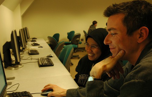 All smiles, Instructor Jim Loter with a student, after class answering questions, computer lab, Infomatics, iSchool, University of Washington, USA by Wonderlane