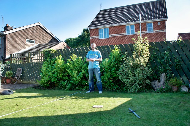 Ben (our five year-old) photographing Doug helping Mark measure the garden
