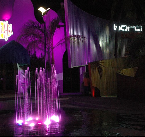 That night life strobe look - lighted pink fountain, bora, bali hai, palm tree, arches, steel, contemporary architecture, Mazatlán, Sinaloa, Mexico by Wonderlane