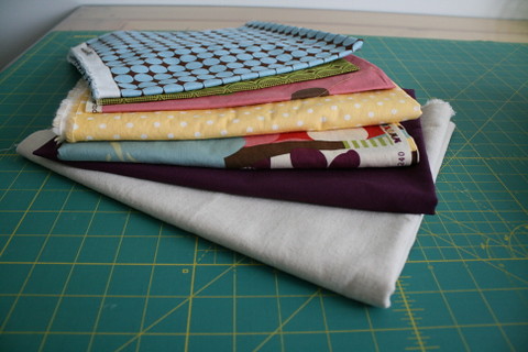 Stacks of fabrics for projects on the list