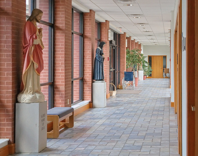 Saint Vincent de Paul Roman Catholic Church, in Perryville, Missouri, USA - view down hallway with statues