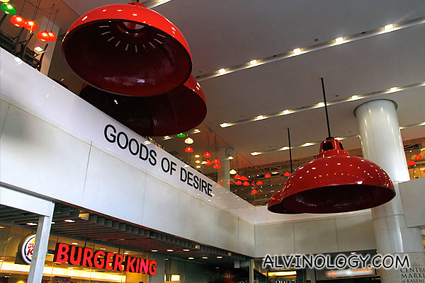 UFO-like red lampshades along the escalator leading up to the store