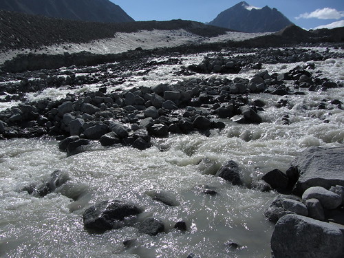 stream pours down from the glacier