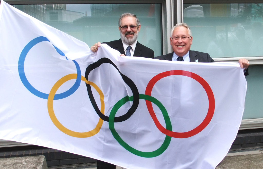 Bob Neill raises the Olympic flag outside Eland House