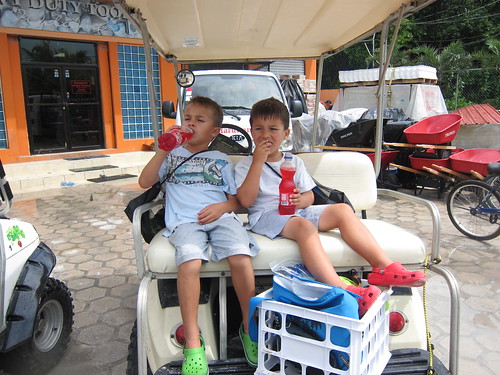 On the golf cart, having a Fanta