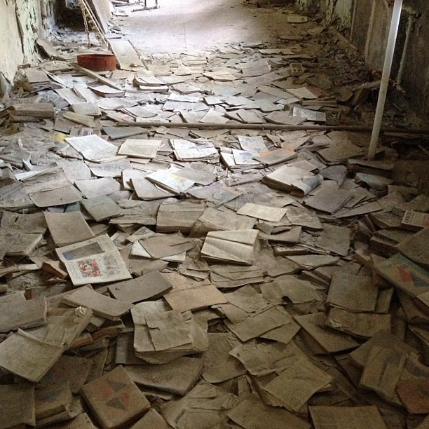 Books strewn about an abandoned school hallway #chernobyl
