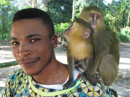 Danny, a bushmeat buyer, with baby lesulas in Obenge