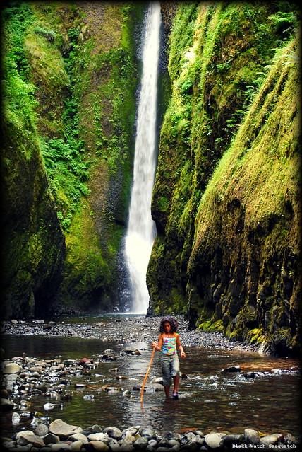 A young hiker at the waterfall at the end of Oneonta Gorge