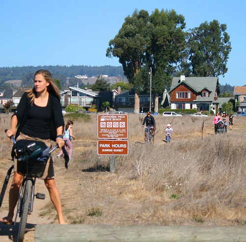 People bike and walk to West Cliff Drive across Lighthouse Field